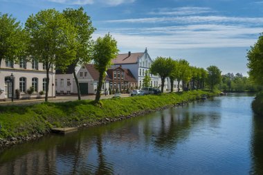 picturesque view of colorful houses near river, Friedrichstadt In Schleswig Holstein clipart