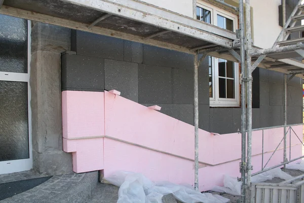 thermal Insulation of old building with pink blocks