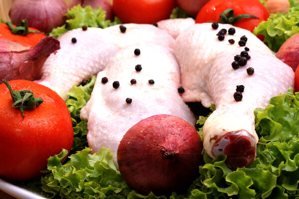 Raw chicken with vegetables close up
