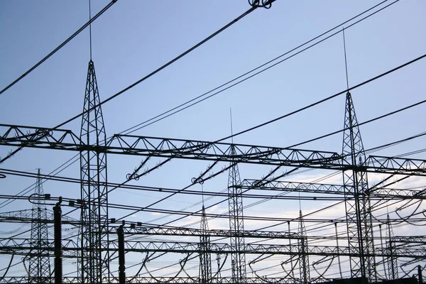 High voltage transmission towers on blue sky background