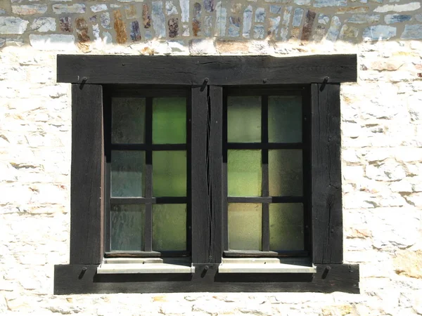 wooden brown Window in stone wall