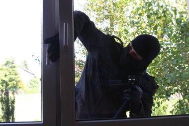 criminal Burglar in black clothes in balaclava on head clipart