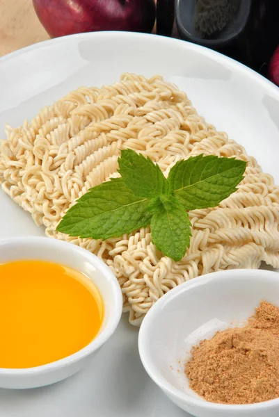 asian noodles with aromatic powder and mint leaves