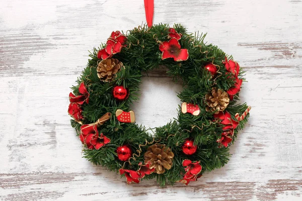 christmas wreath rotating on wooden wall, close-up