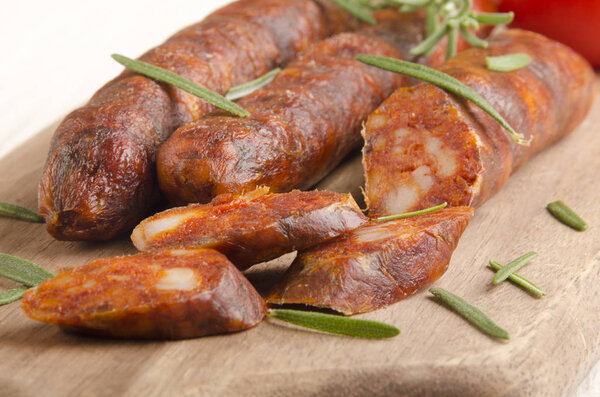 Home Made Sliced Spanish Chorizo With Rosemary On Wooden Board