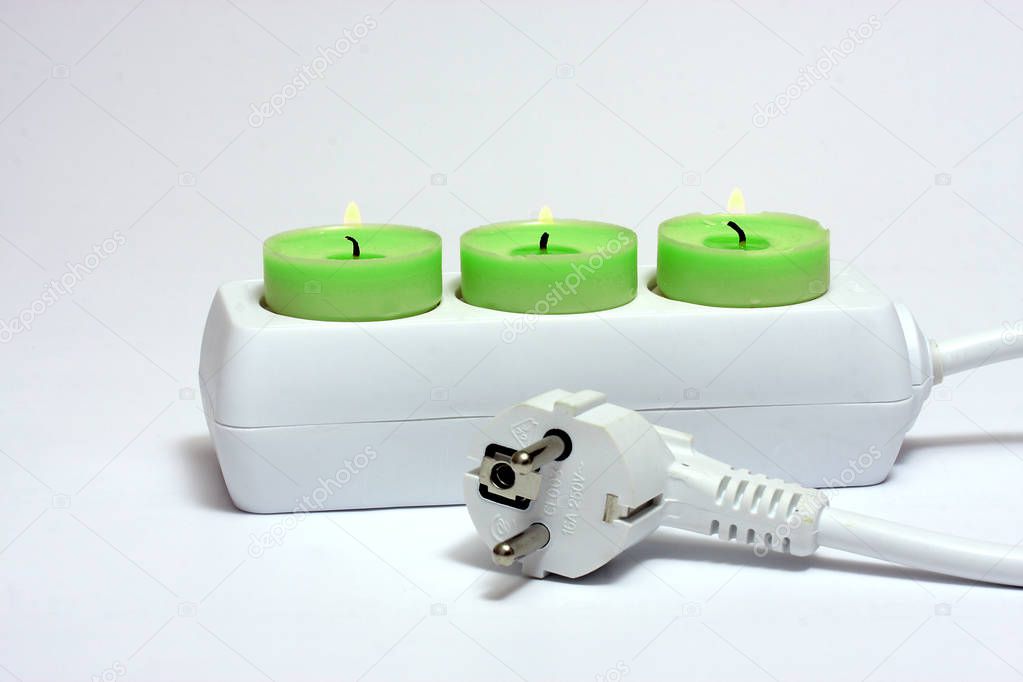 colorful candles in electrical extension,concept of green electricity 