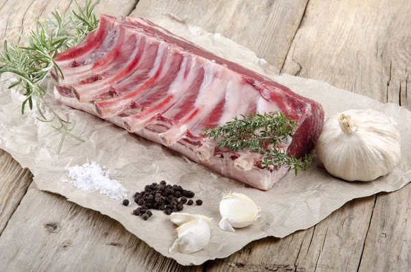 Raw Rack Lamb French Style Thyme Garlic Pepper Brown Paper — Stock Photo, Image