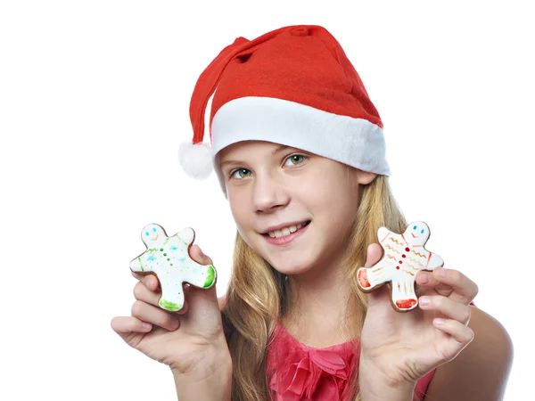 Meisje met gingerbread man kerstkoekjes in handen — Stockfoto