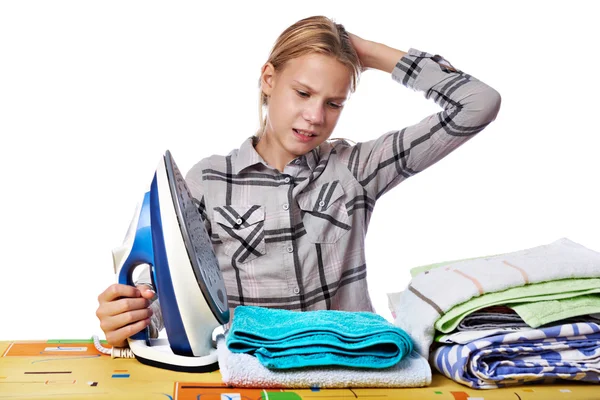 Tired girl with washed linen around ironing board and iron isola — Stock Photo, Image