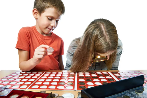 Boy and girl are considering coin collection isolated — ストック写真