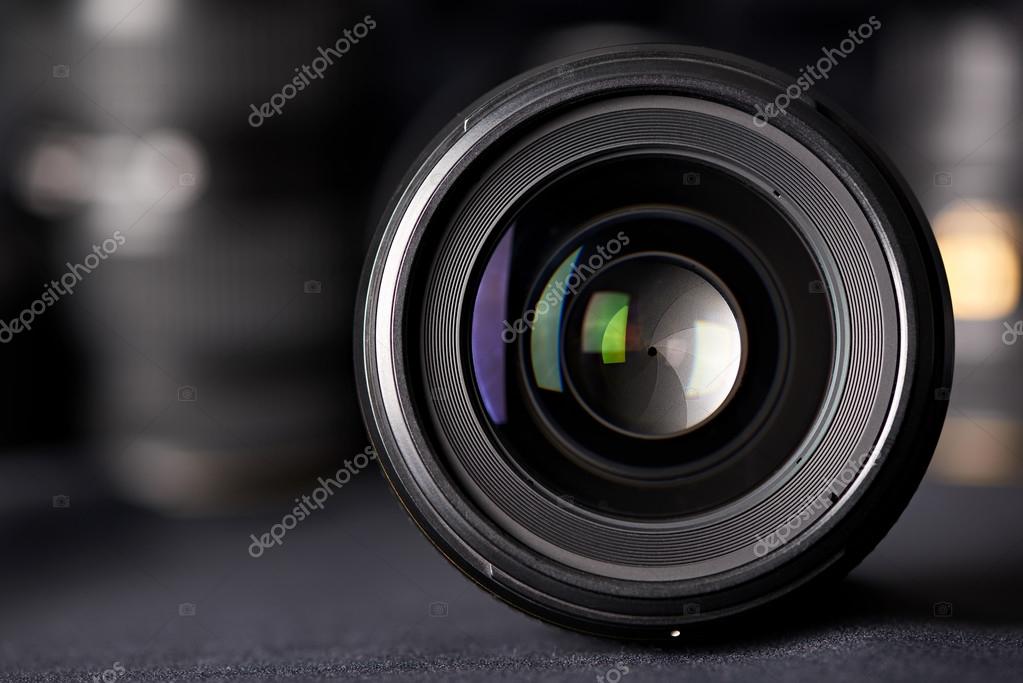 Photo lens front view on blurred texture — Stock Photo © ryzhov 128779510