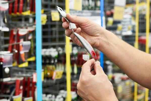 Appât leurre de pêche dans les mains de l'homme en magasin — Photo