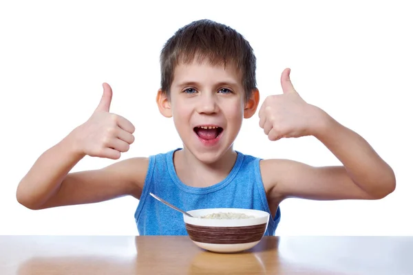 Menino feliz comer mingau isolado — Fotografia de Stock