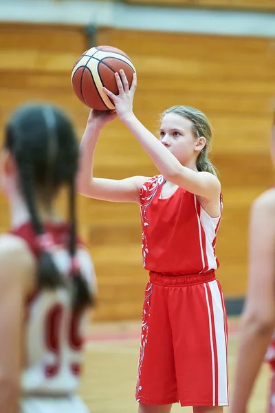 Girl in sport uniform playing basketball