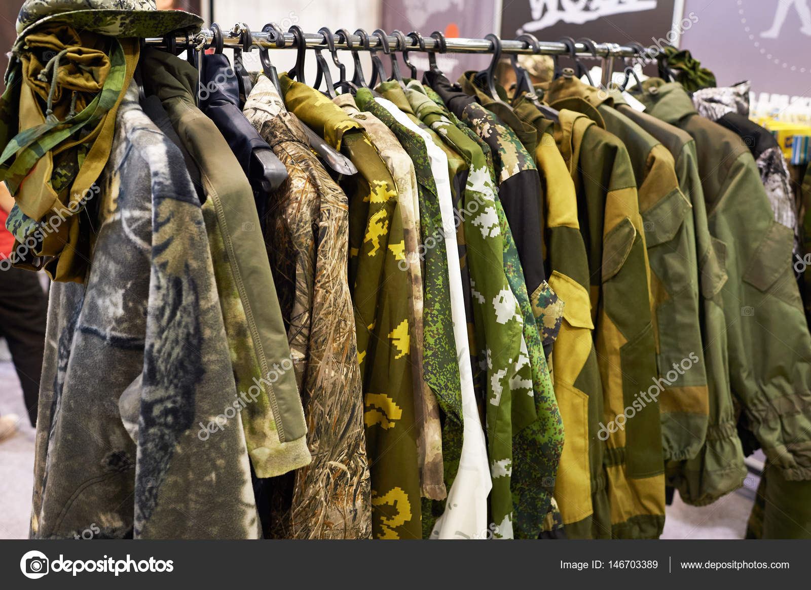 Jackets for hunting and fishing on hanger in store — Stock Photo