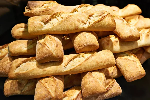 Fresh baguettes of white bread on store — Stock Photo, Image