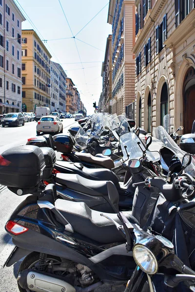 Parked scooters and motorcycles on street — Stock Photo, Image