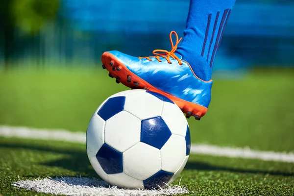 Foot of soccer player in football boot on ball — Stock Photo, Image