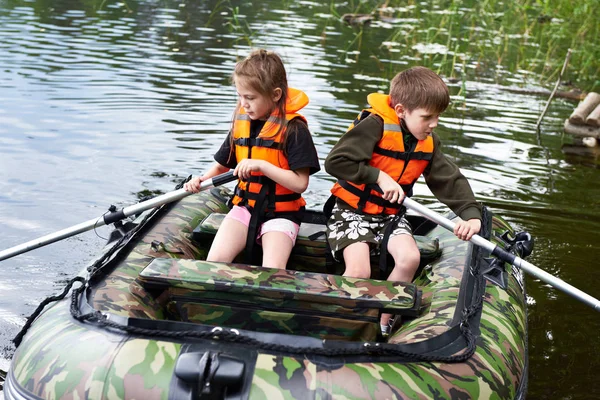 Children in life jackets swimming on boat