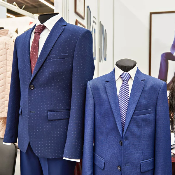 Мужские костюмы с рубашками и галстуками в магазине одежды — стоковое фото