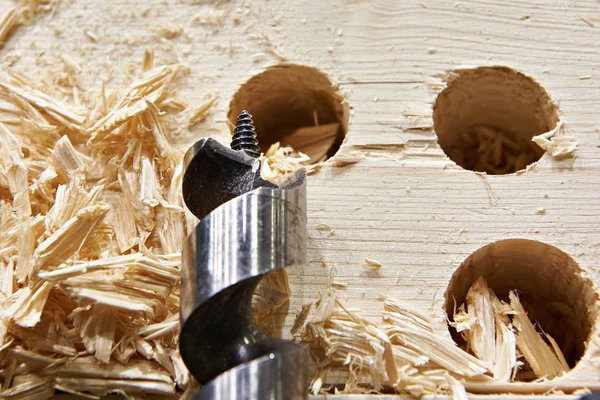 Drill for wood, hole of board and shavings — Stock Photo, Image