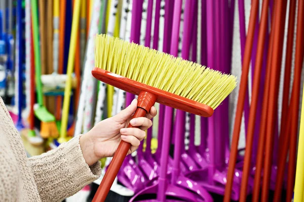 Woman hand with floor brush in store — Stock Photo, Image