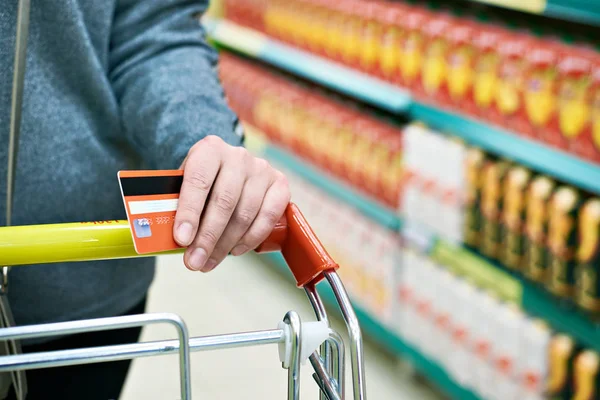 Bank card in hand at store — Stock Photo, Image