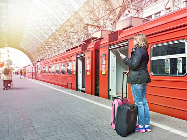 Woman with suitcases near train on station — Stock Photo, Image