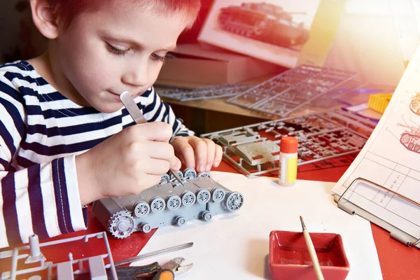 Little Boy Collects Plastic Model Tank Home Workplace — Stock Photo, Image