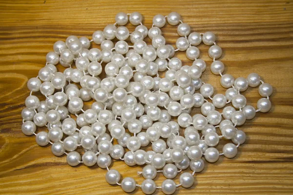 Pearls isolated on a wooden background — Stock Photo, Image