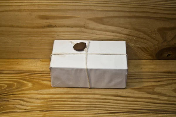 Parcel isolated on a wooden background — Stock Photo, Image