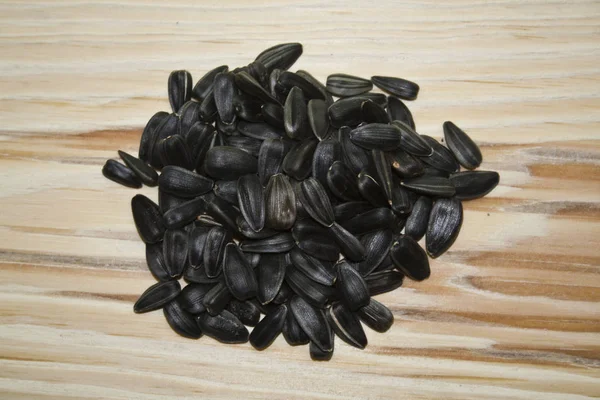 Sunflower seeds isolated on a wooden background — Stock Photo, Image