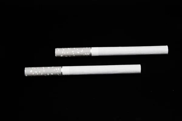 Cigarette isolated on black background — Stock Photo, Image