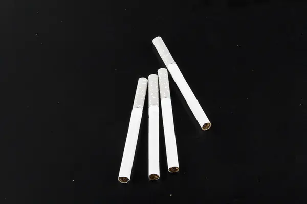 Cigarettes isolated on black background — Stock Photo, Image