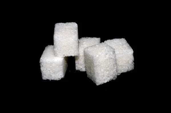 Sugar cubes isolated on black background — Stock Photo, Image