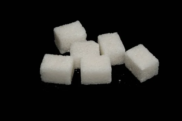 Sugar isolated on black background — Stock Photo, Image