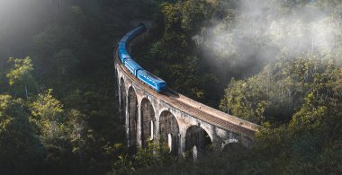 Train arriving at famous Nine arches bridge in Ella, Sri Lanka clipart