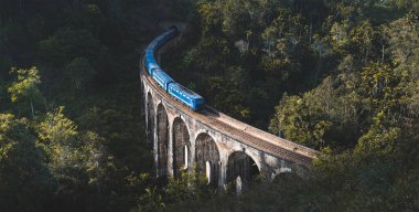 Train arriving at famous Nine arches bridge in Ella, Sri Lanka clipart