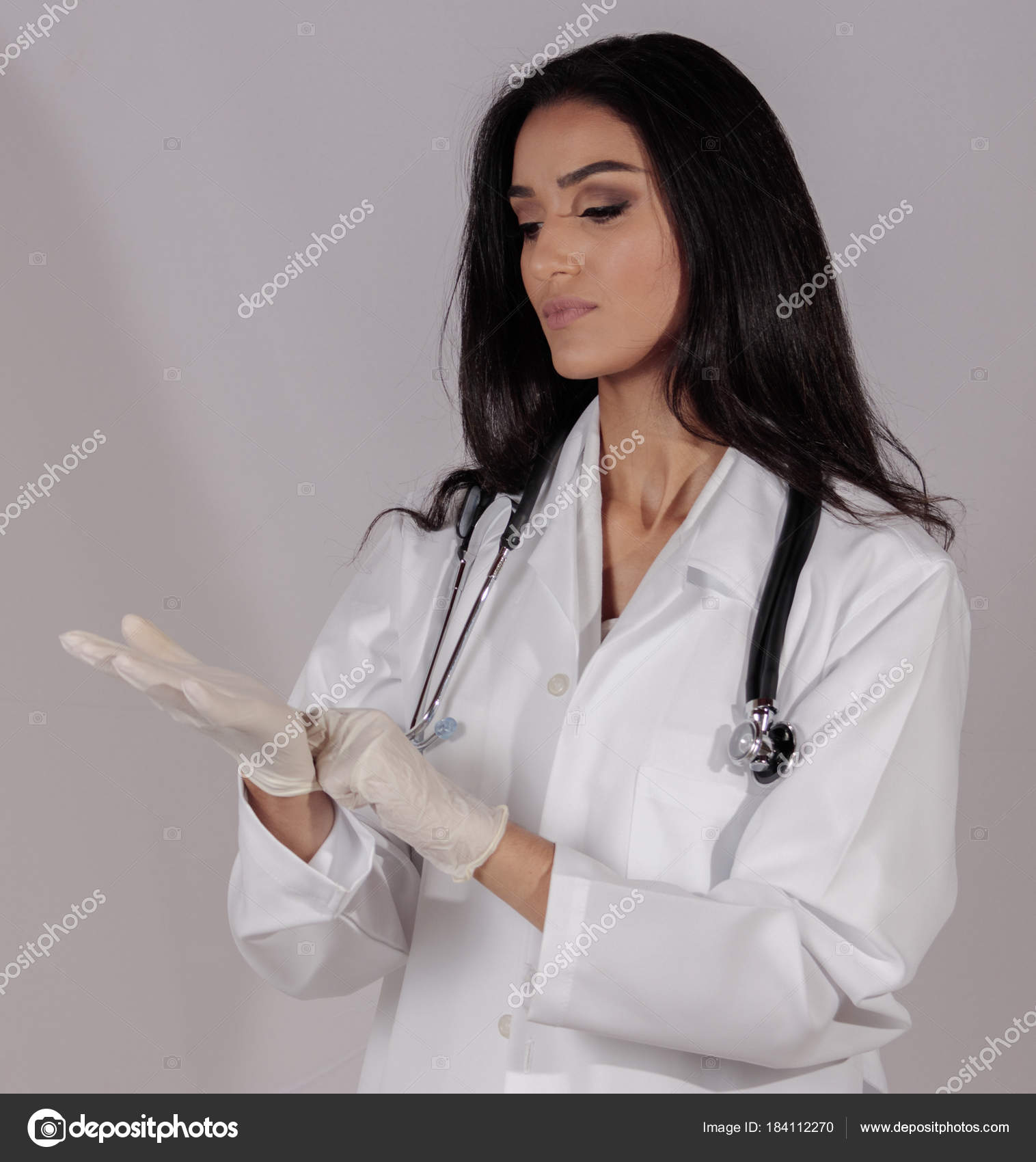 Beautiful Long Hair Female Doctor Wearing White Overcoat Gloves Stethoscope  Stock Photo by ©motuspix 184112270
