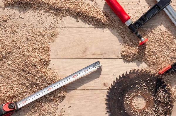 carpentry tools in wood shavings on a wooden background from oak planks with expressive texture and natural pattern