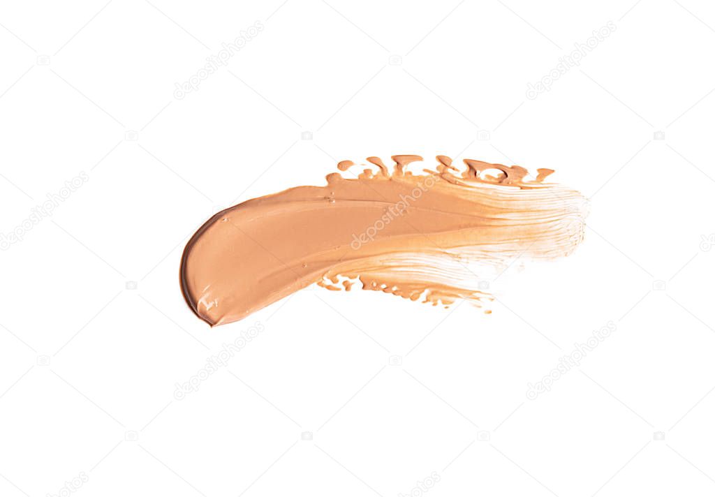 Gently beige smear of makeup creamy foundation isolated on white background.