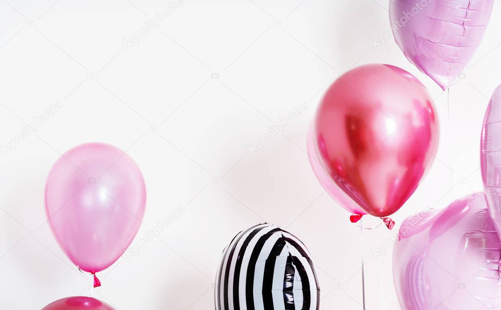 Set of balloons in the form of a heart and round pink and striped on light background with copy space.
