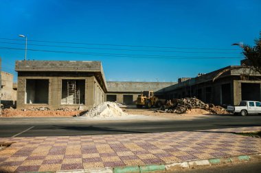 Construction of a building on one of the town streets, Umm Aldoom, Saudi Arabia