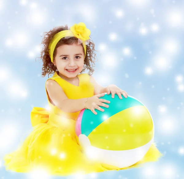 Little girl in yellow dress with big ball — Stock Photo, Image