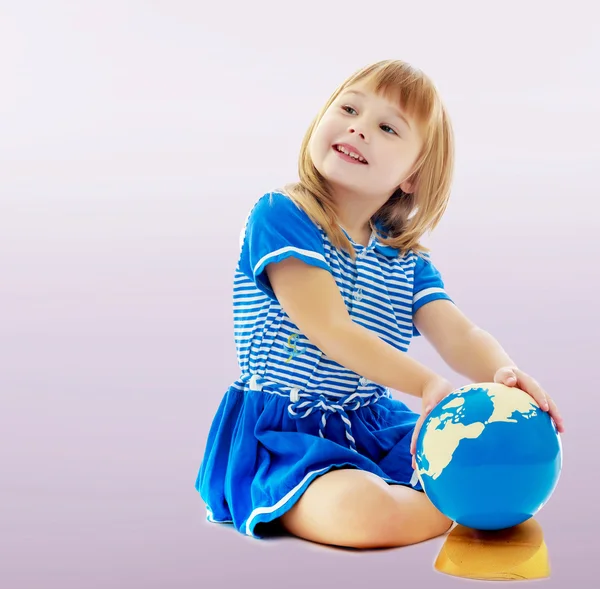 Girl turns hand globe — Stock Photo, Image