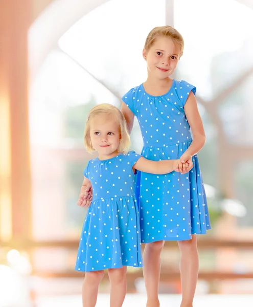 Sisters in blue dresses — Stock Photo, Image