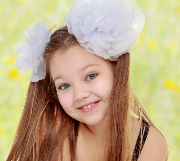 Beautiful little girl with white bows on the head — Stock Photo, Image