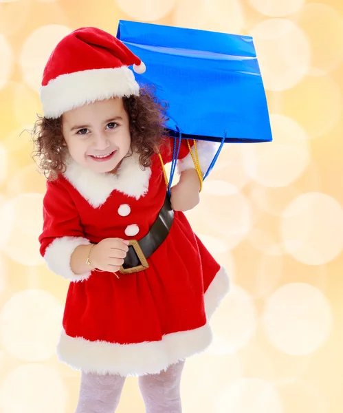 Liten flicka i kostym Santa Claus med färgglada paket — Stockfoto