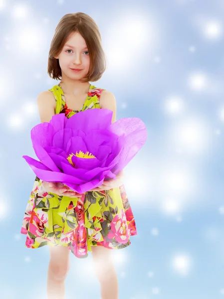 Bambina che tiene un grande fiore viola — Foto Stock