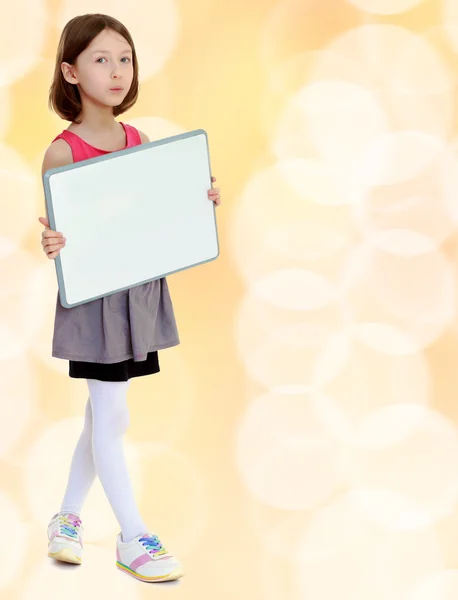 Little girl holding white poster. — Stock Photo, Image